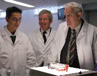 A set of images of Tariq Ashkanani and Clara Calvert showing two men, possibly named "Tam" and "Prin", a chemistry lab containing 3D glasses, a microscope, pipettes and unknown sample.  5 images.